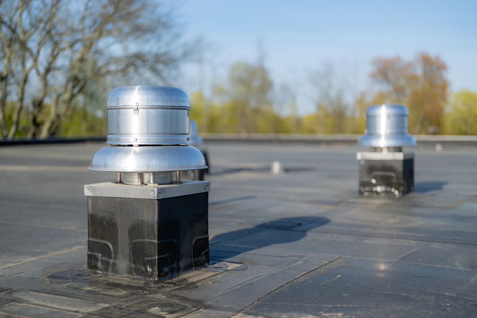 Aluminum roof vents and flashed curbs on a commercial EPDM flat roof installed by Signature Roofing