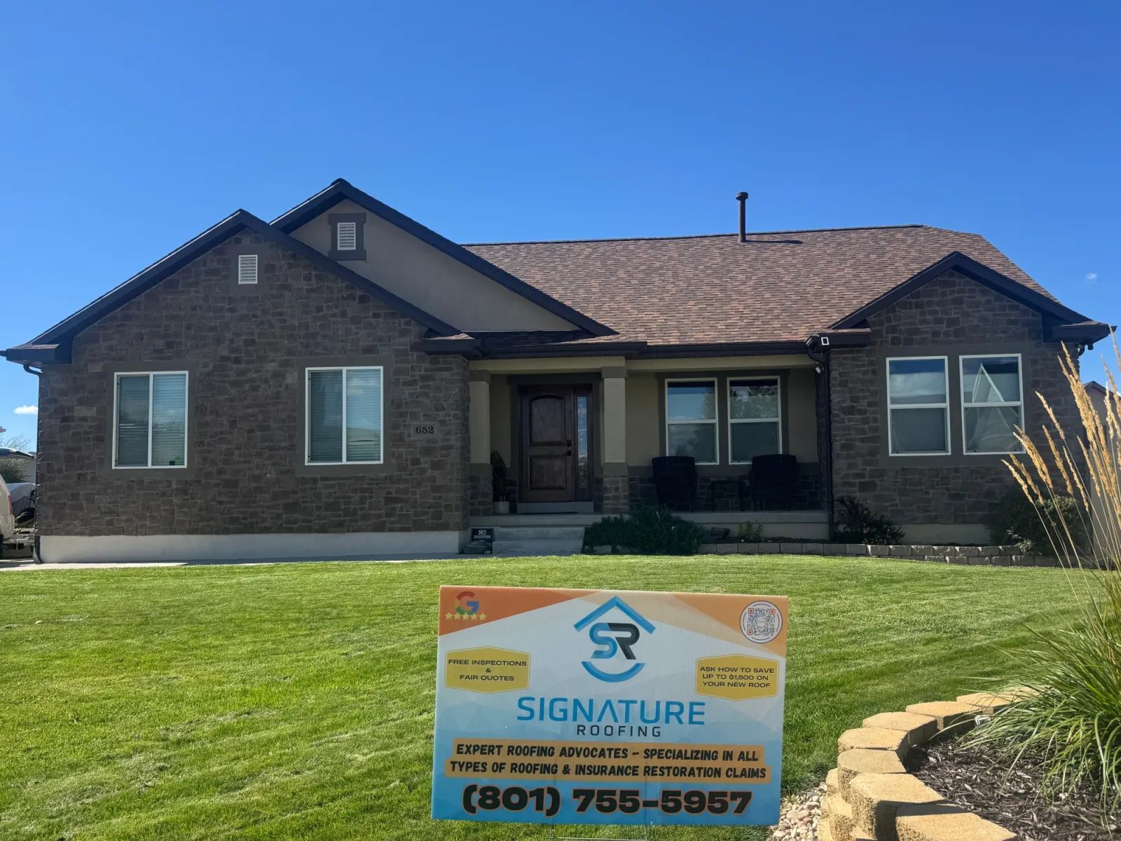 Utah home with full stone veneer exterior and stucco accents completed by Signature Roofing